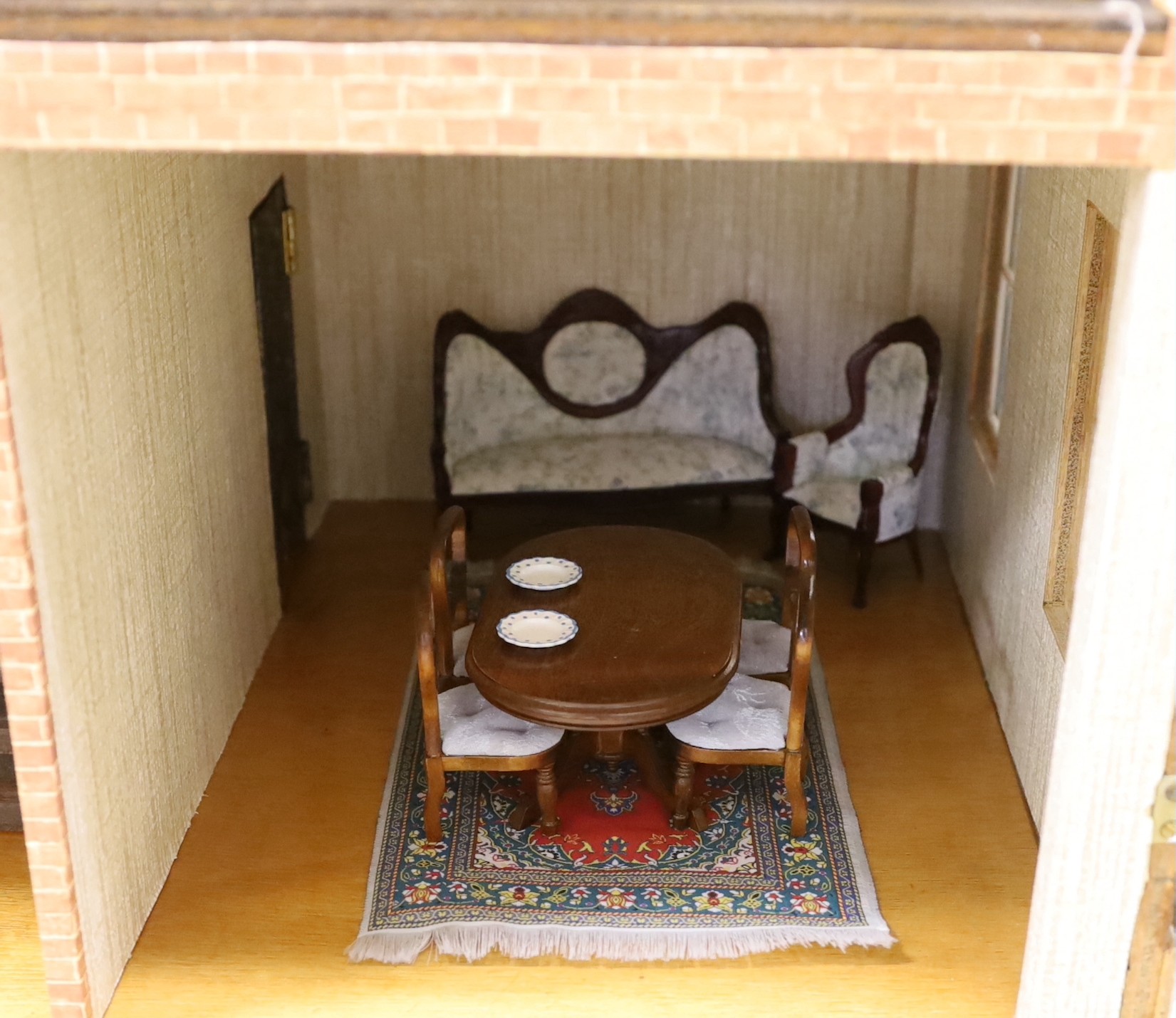 A mid 20th century doll's house and contents, 84cms x 100cms high